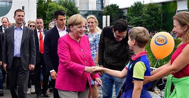 Merkel has no regrets over refugee policy despite political cost