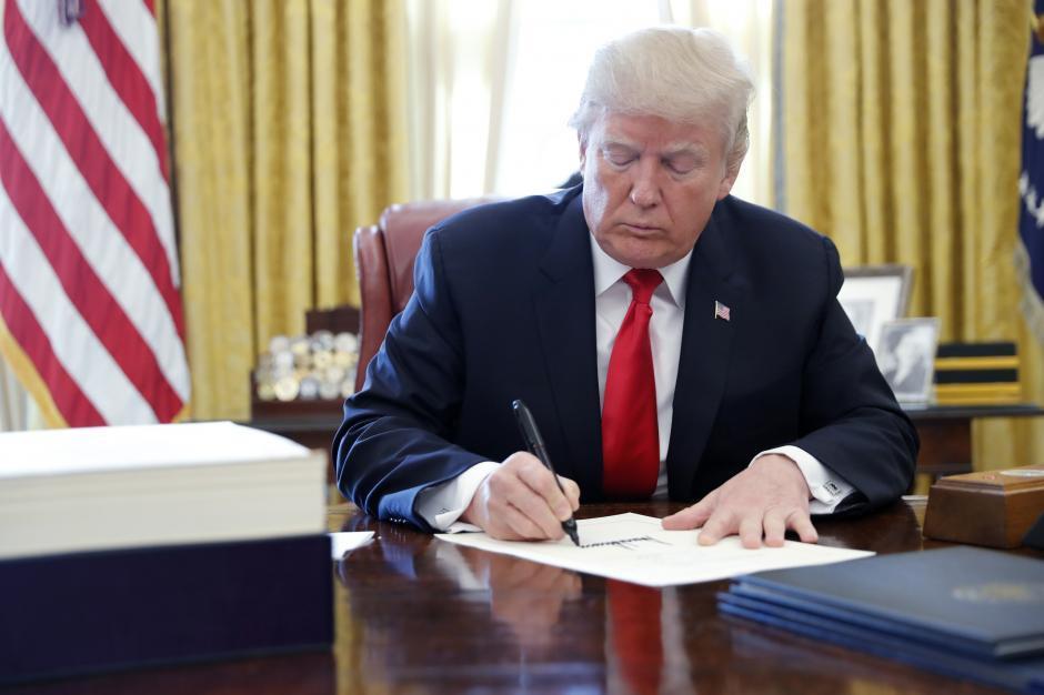 Trump signs tax, government spending bills into law