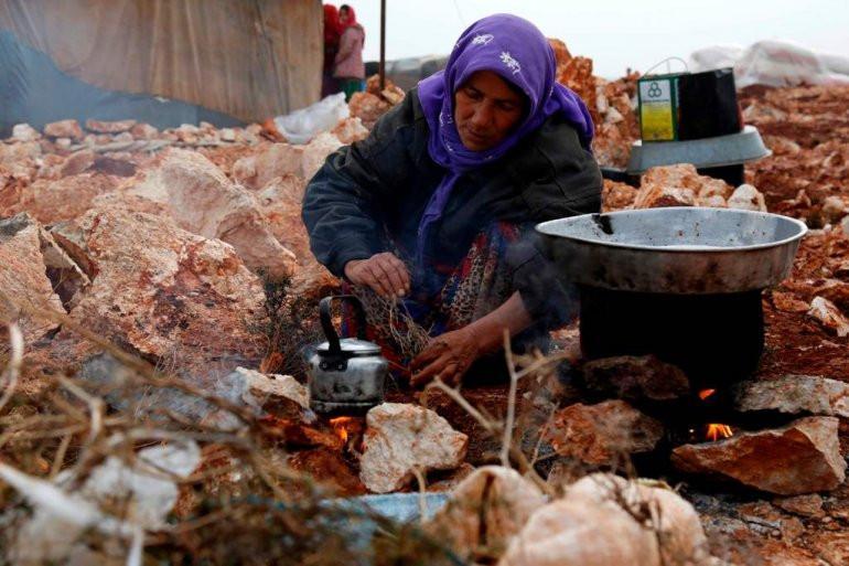 Syrians displaced by Idlib assault take shelter near Turkey
