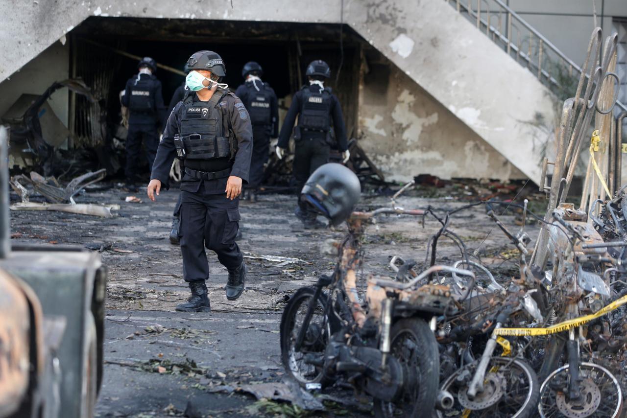 Family of suicide bombers attack Indonesian churches, at least 13 dead