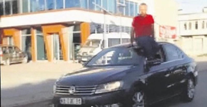 Turkish man fined for driving car with feet while sitting on its roof