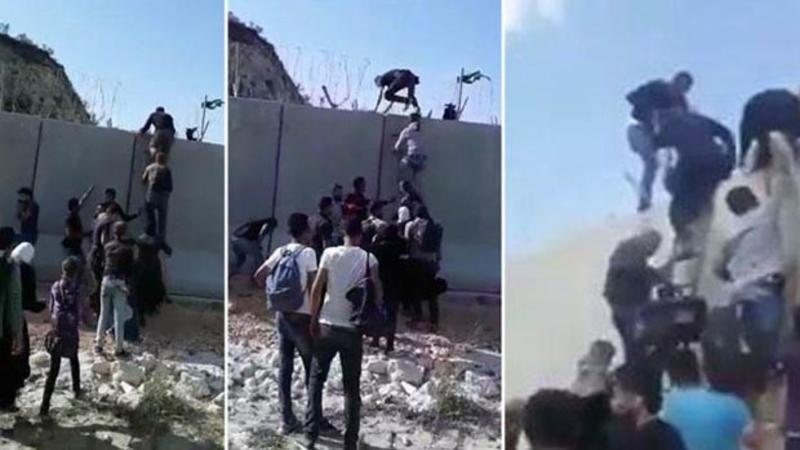 Footage shows Syrians scaling Turkish border wall with ladders