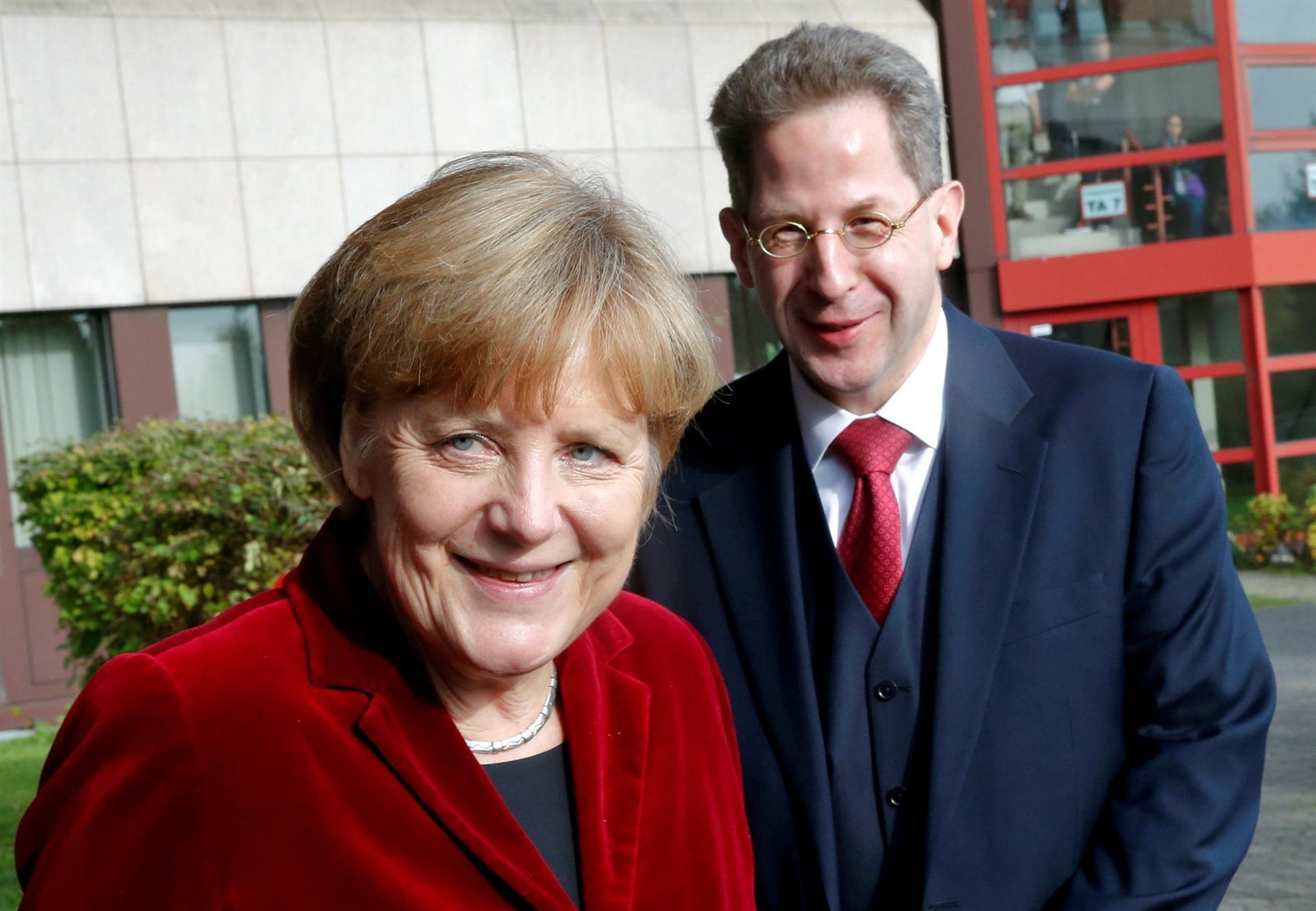 Merkel removes spy chief to defuse row over far-right