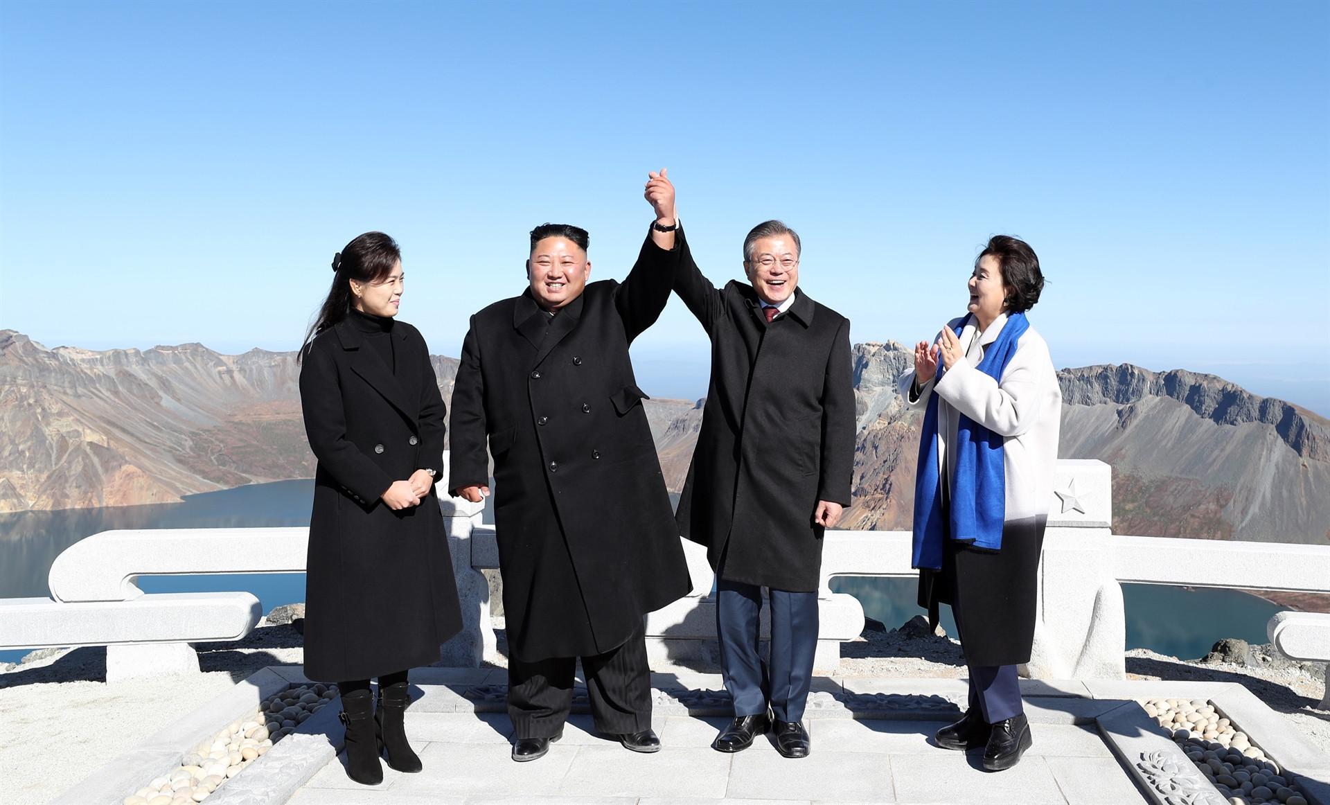 Kim, Moon join hands on peak of sacred North Korean volcano