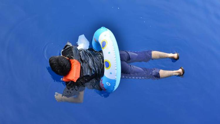 Migrant with child swim ring saved by tourist boat amid desperate bid to cross from Turkey to Greece