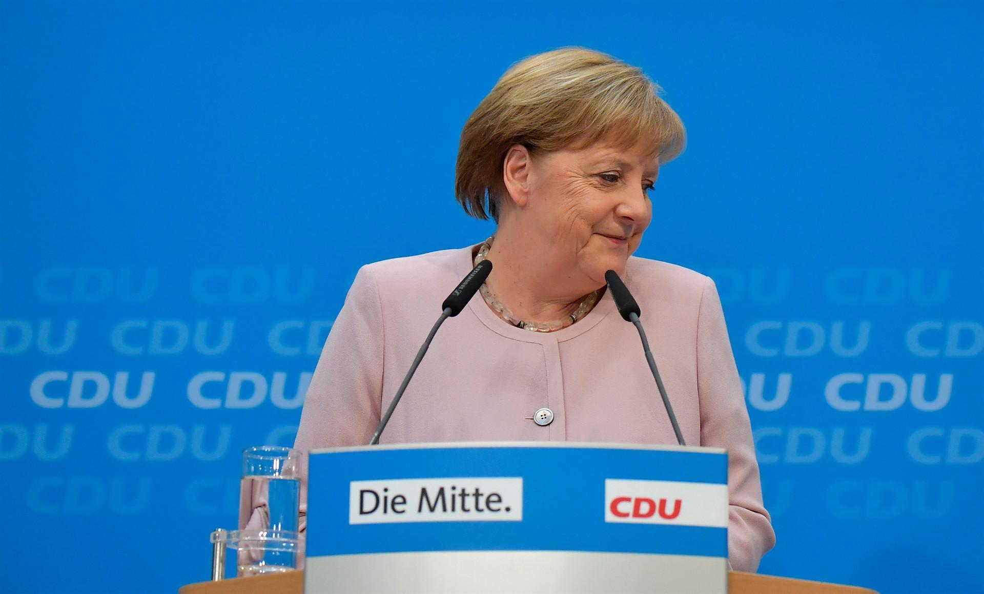 Merkel vows coalition will push on despite jitters as SPD chief quits