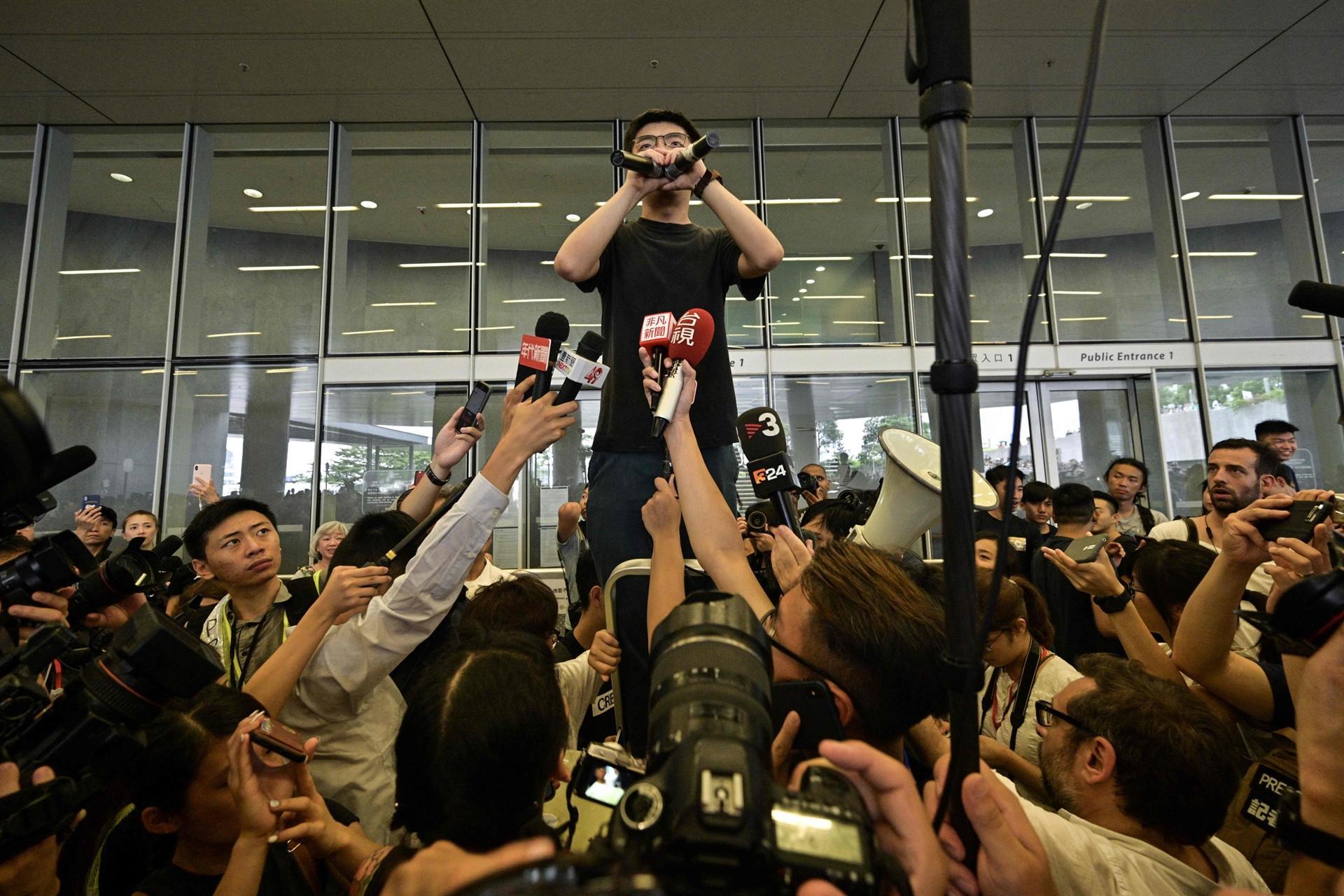 Pressure builds on Hong Kong leader as activist vows to join protests
