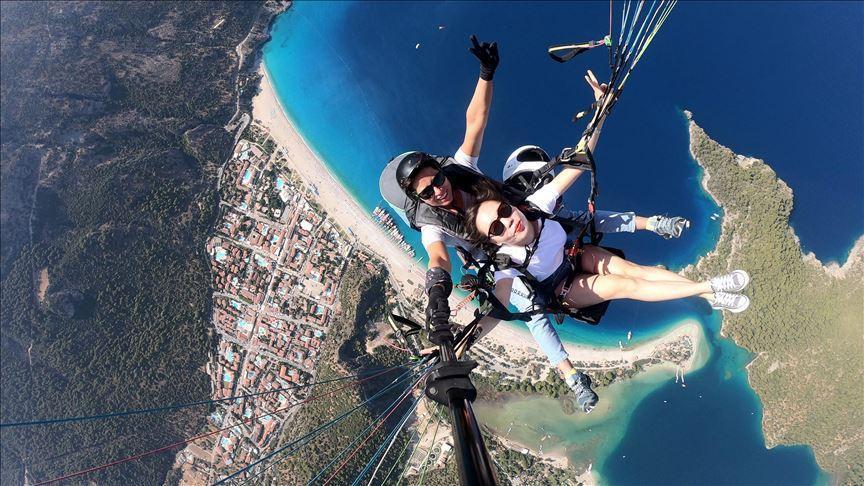 Female paragliders fly tourists over southwest Turkey