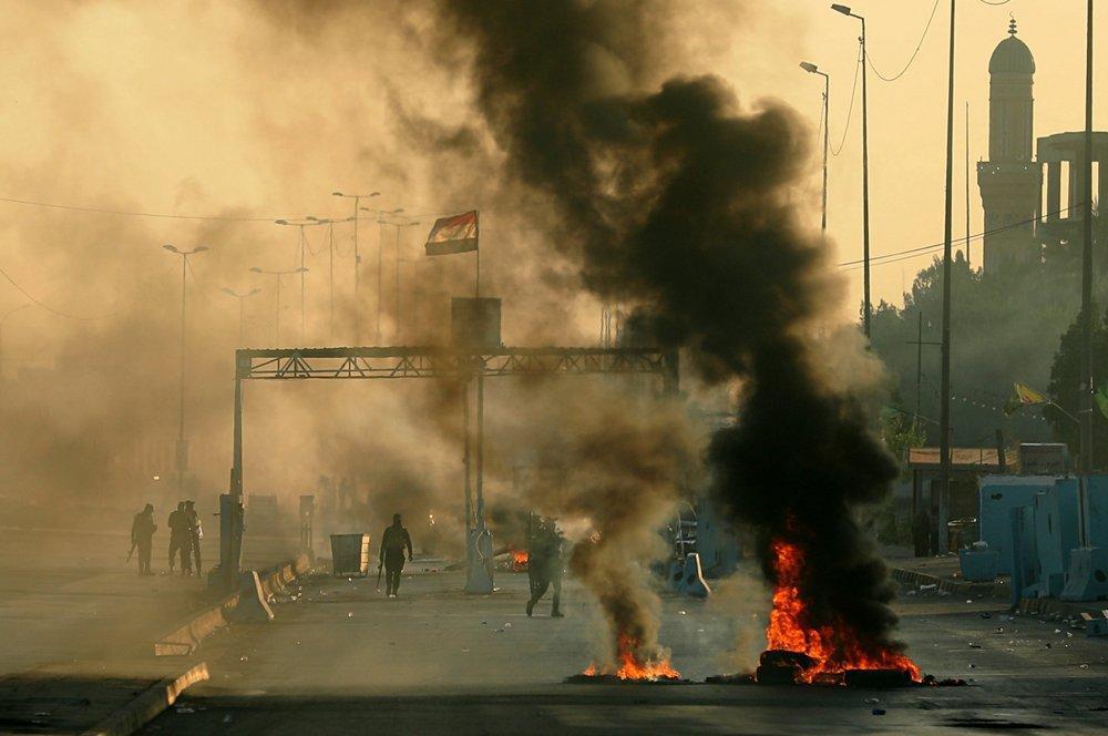 Iraq blames malicious hands as toll from unrest tops 100
