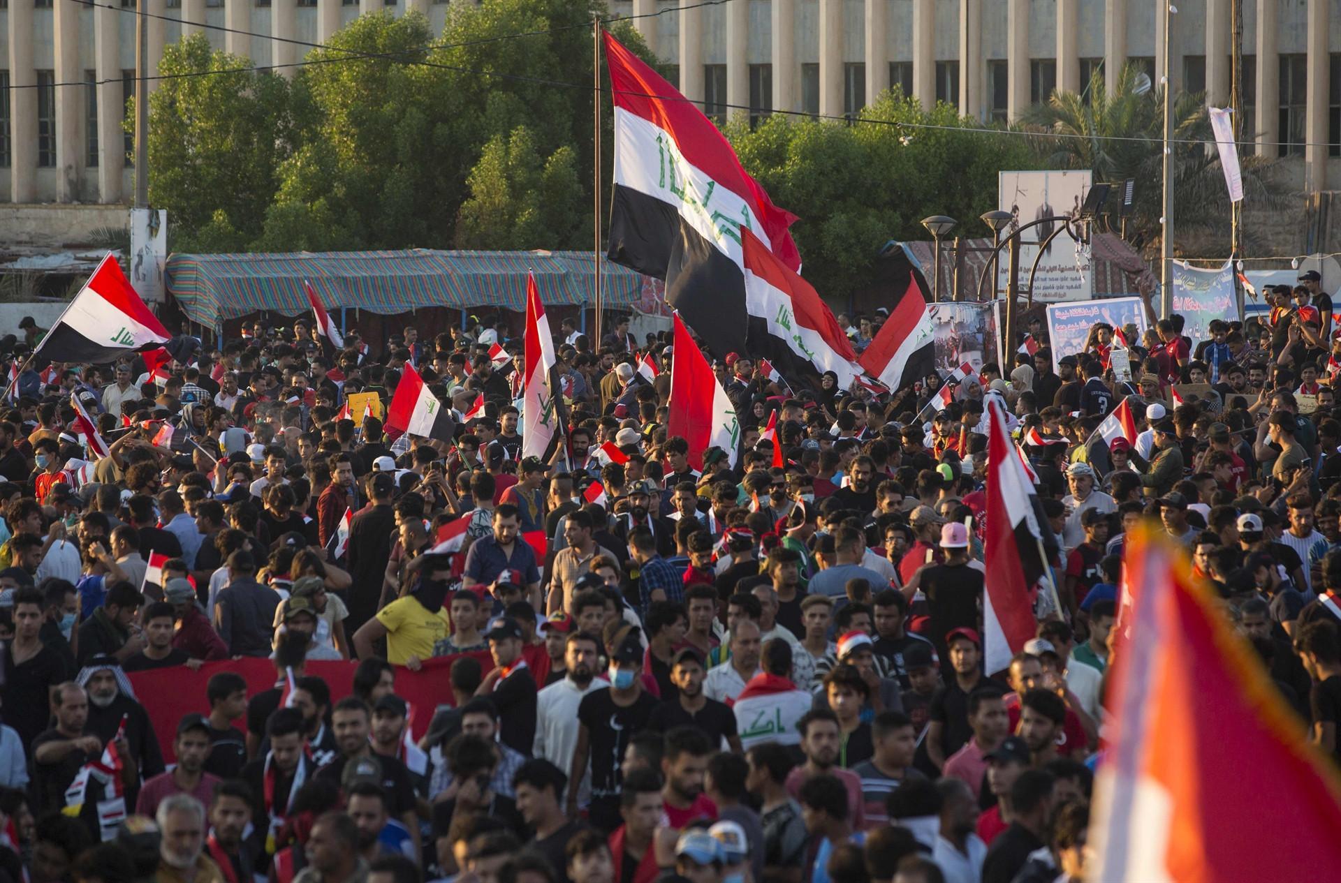 Iraqis defy crackdown to hold biggest protests yet
