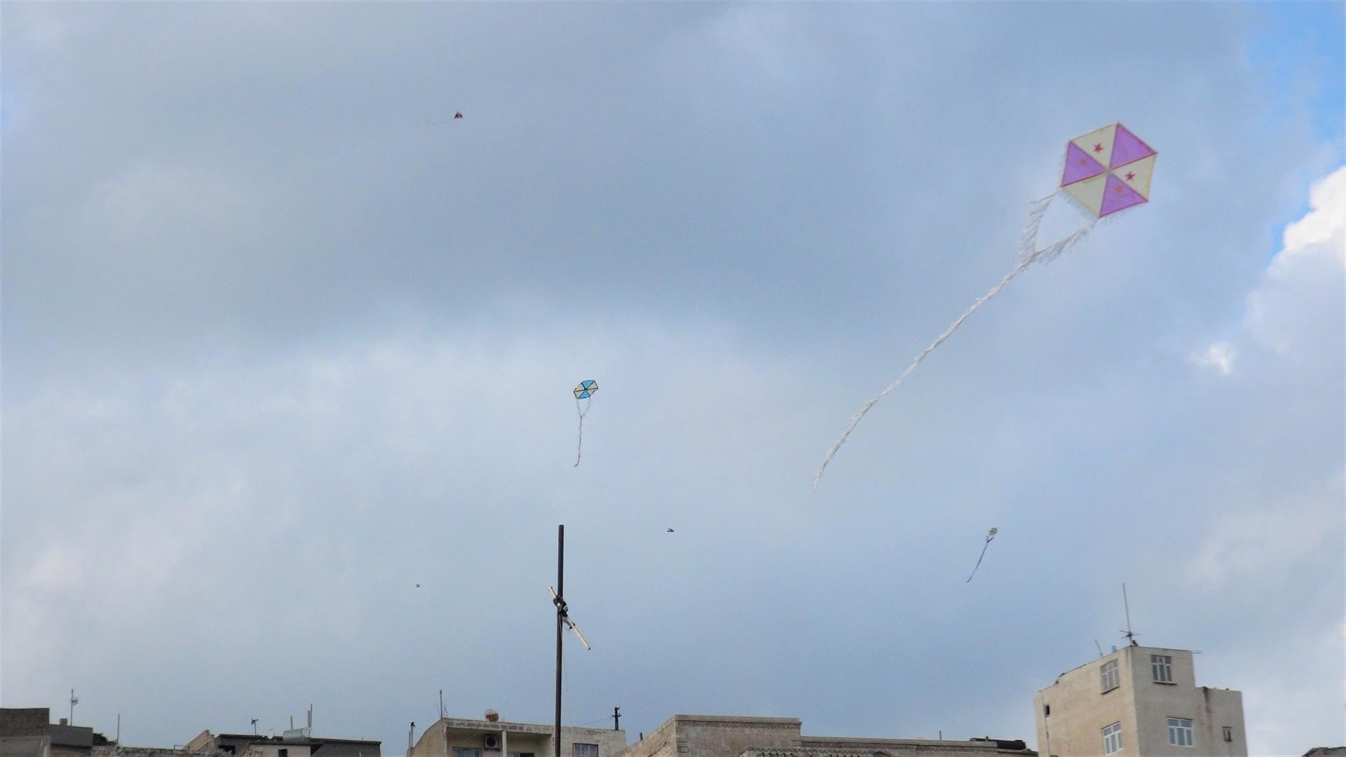 Residents fly colorful kites from rooftops in Turkey’s Mardin