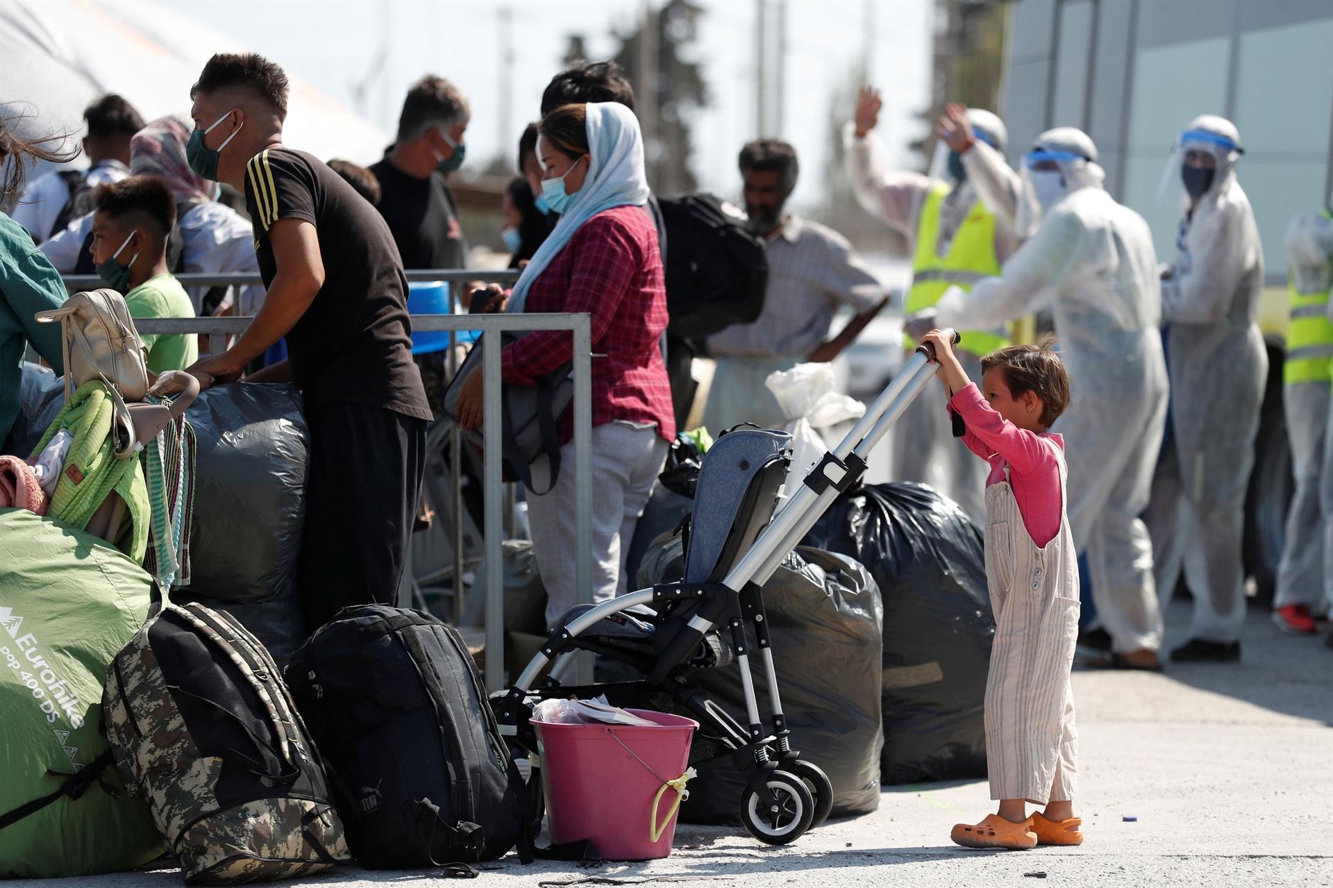 Scores of migrants at new Greek camp contract virus