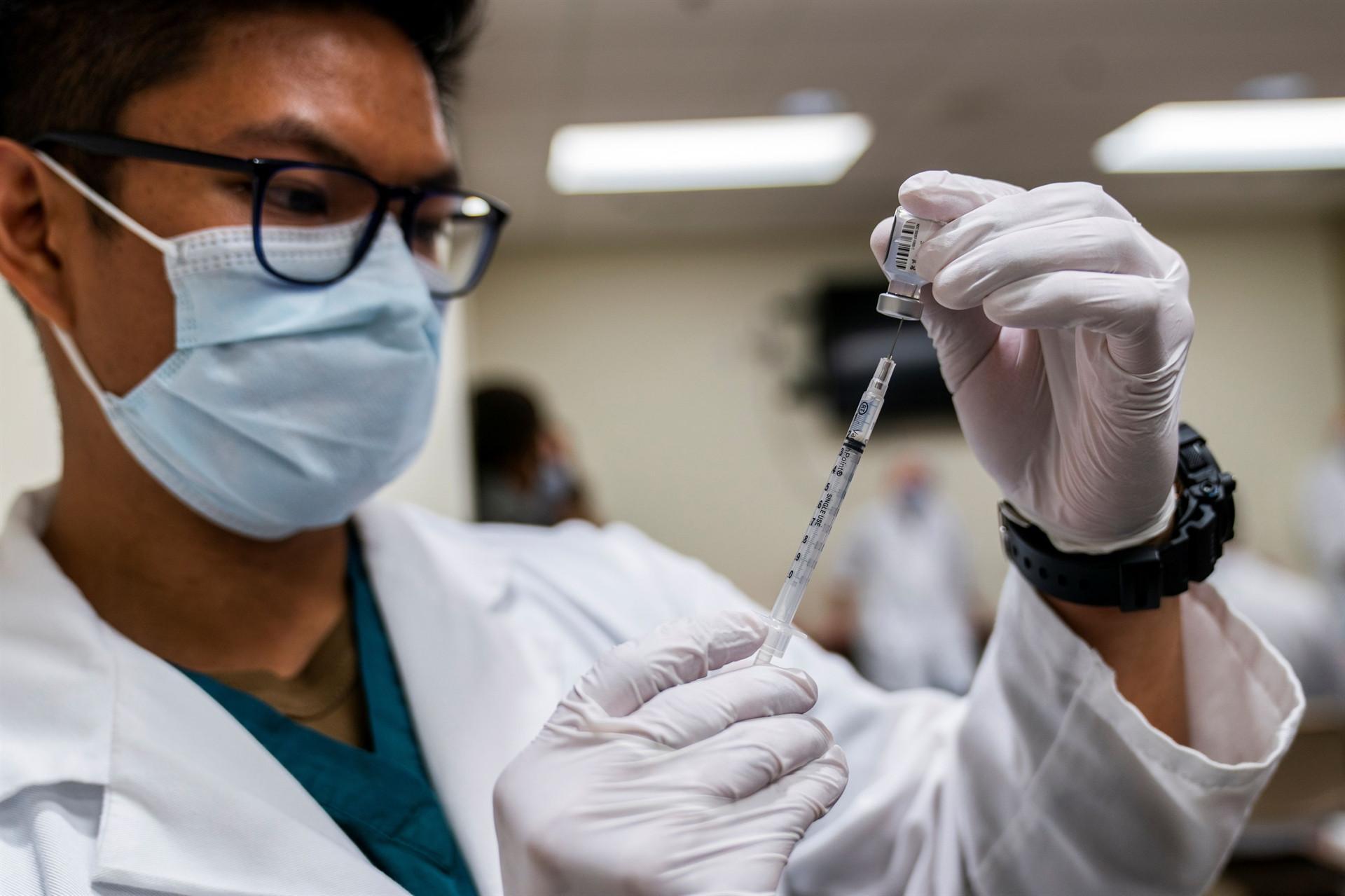 US begins COVID-19 vaccinations as its death toll passes 300,000