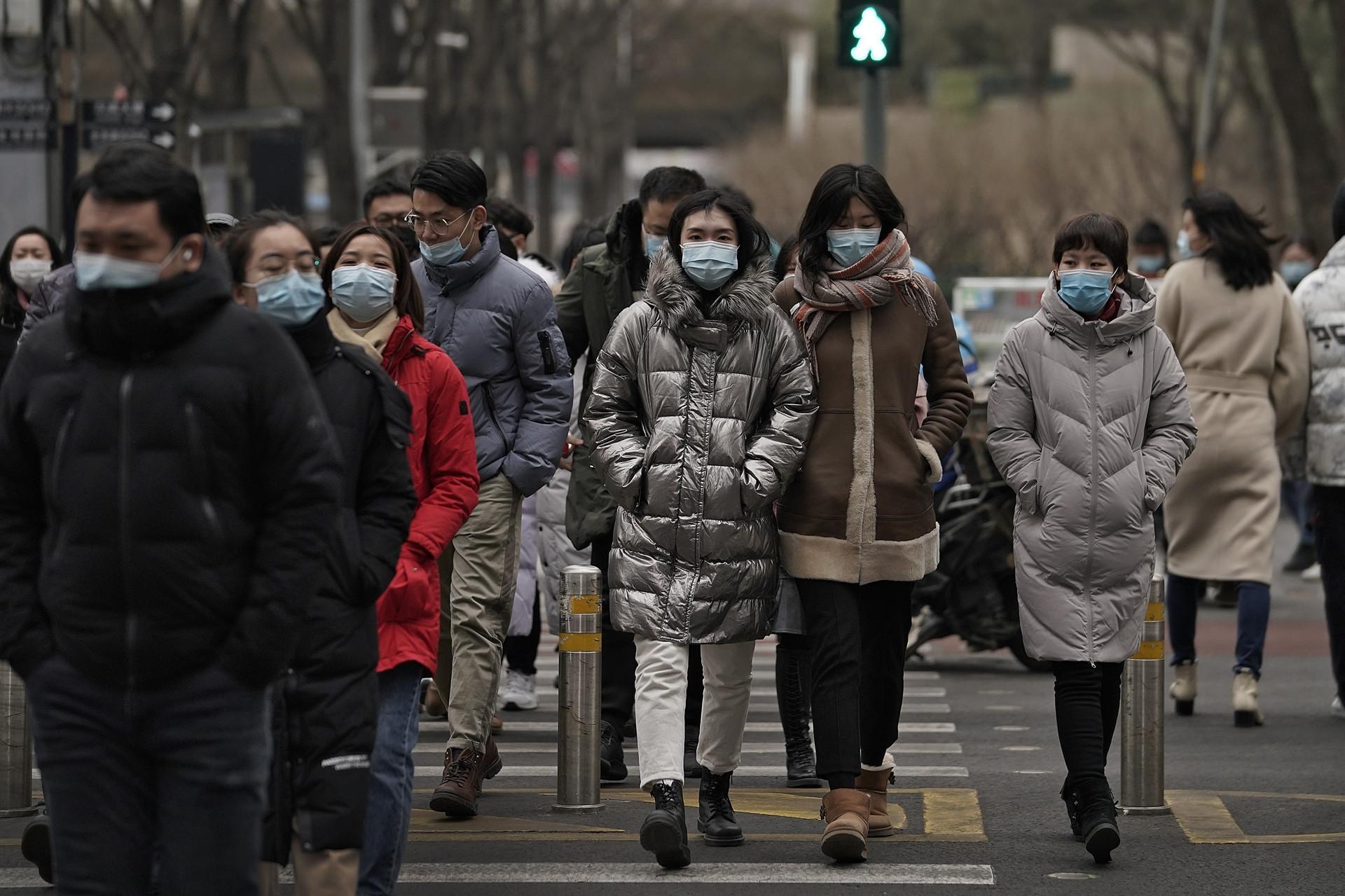 China logs first virus death in 8 months as WHO huddles on new strains