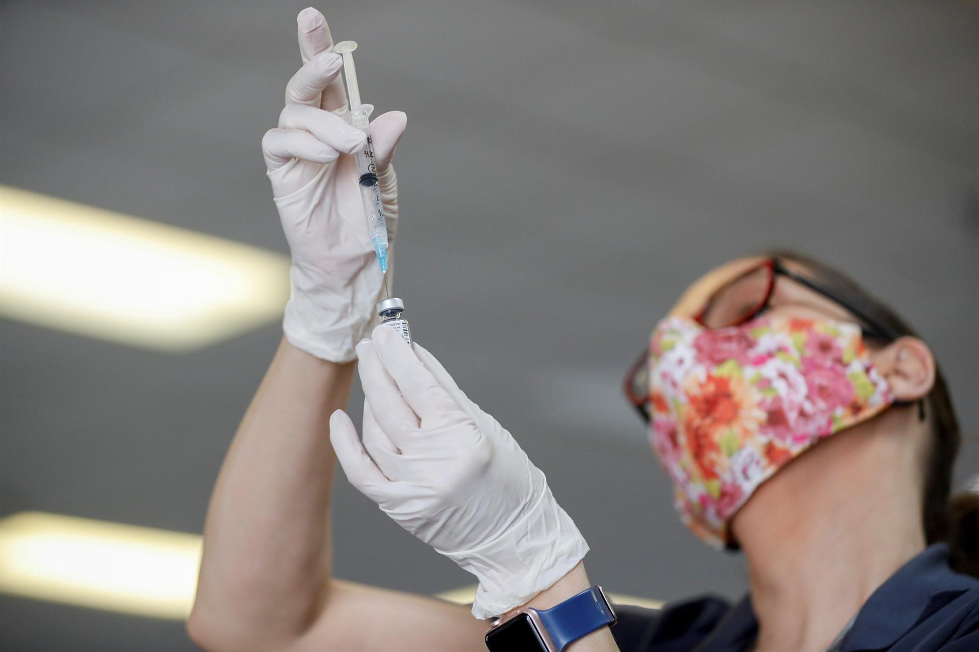 UK virus jabs hit first target as N Zealand puts city in lockdown