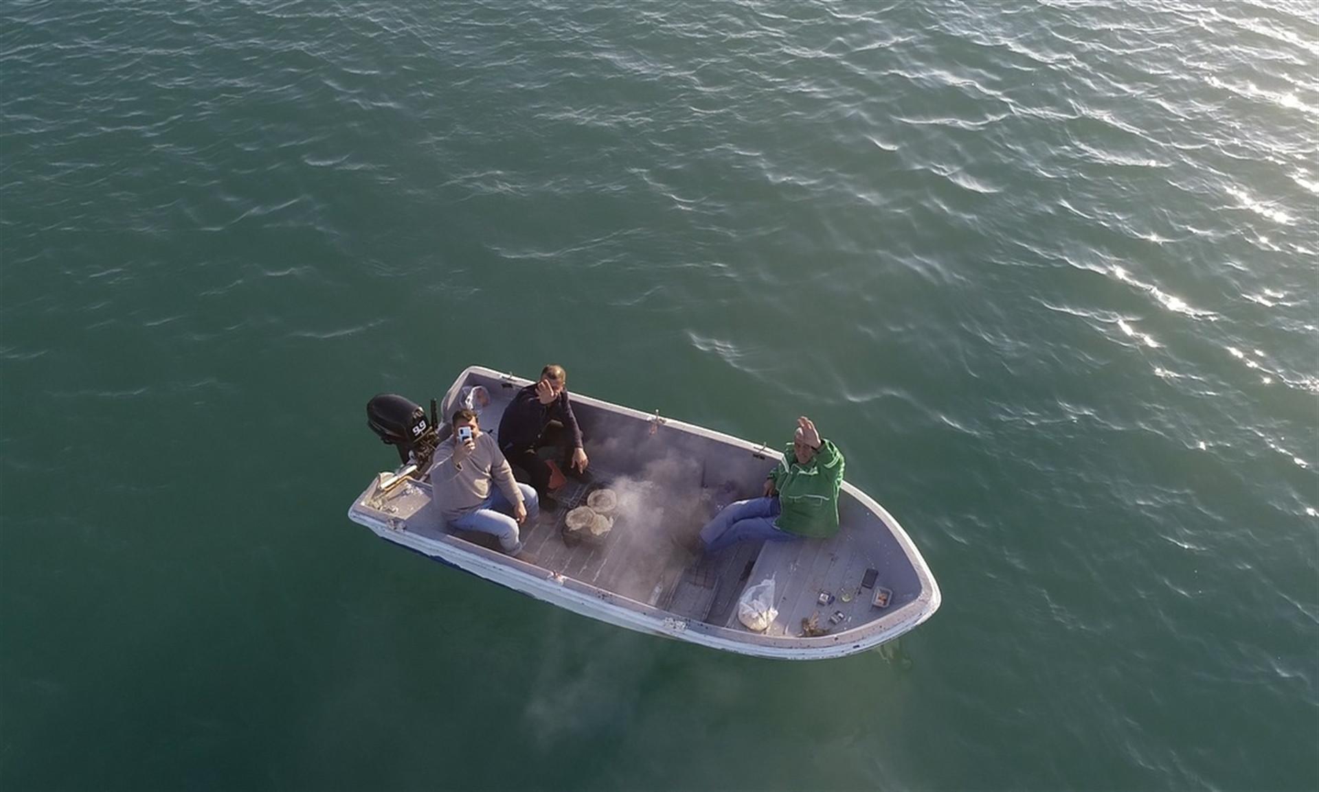 Friends make barbeque on boat due to virus restrictions on land