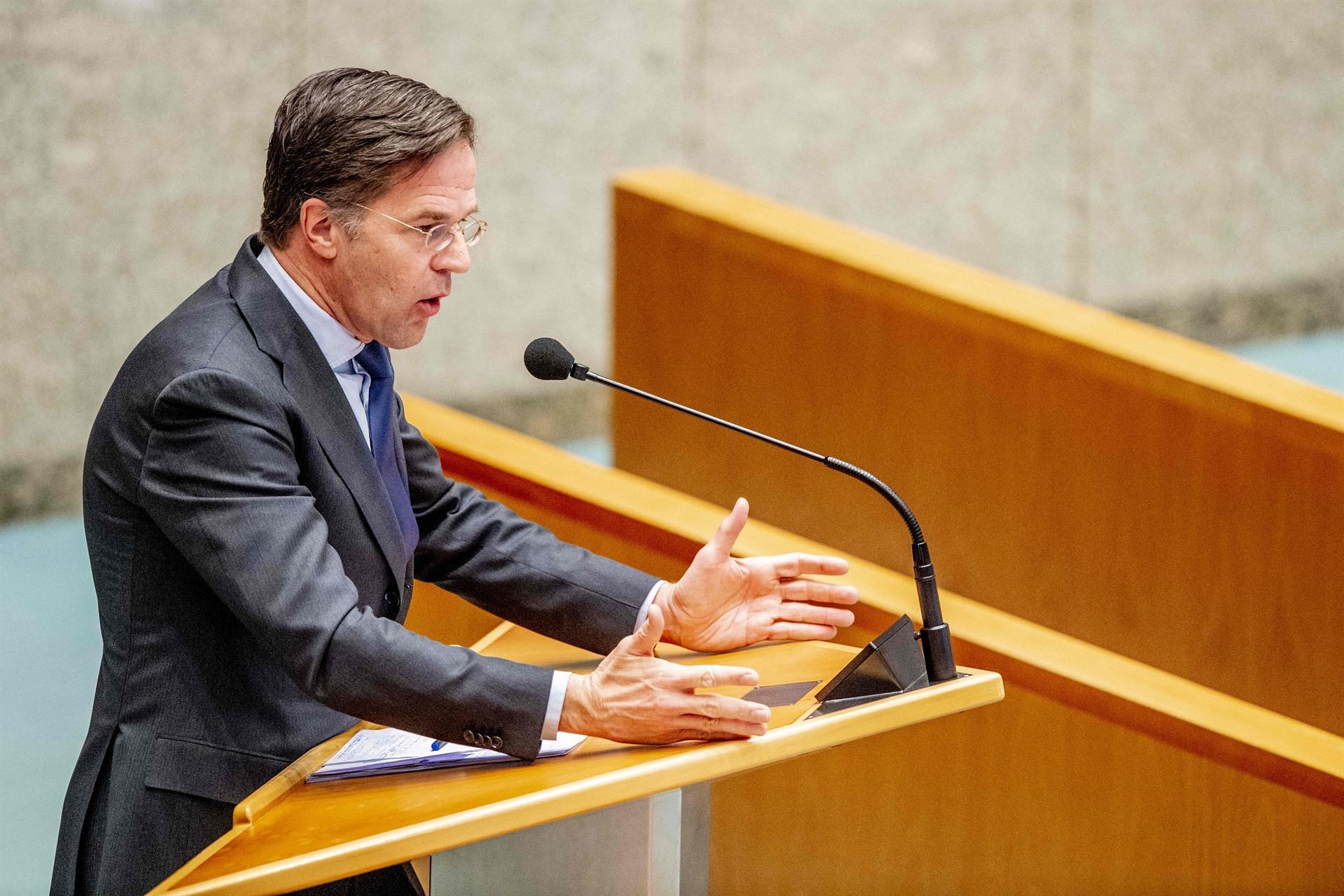 Dutch PM Rutte clings on after political battle