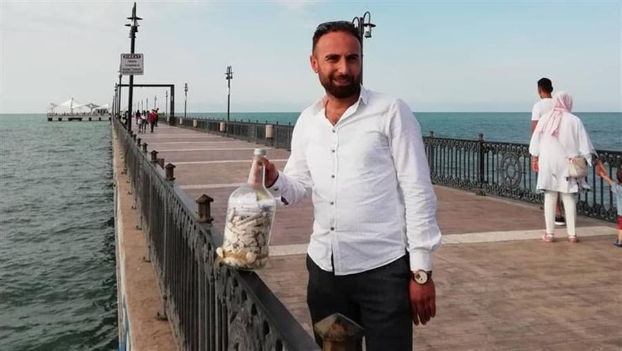 Cafe owner throws wish bottle full of his customers’ messages into Med Sea