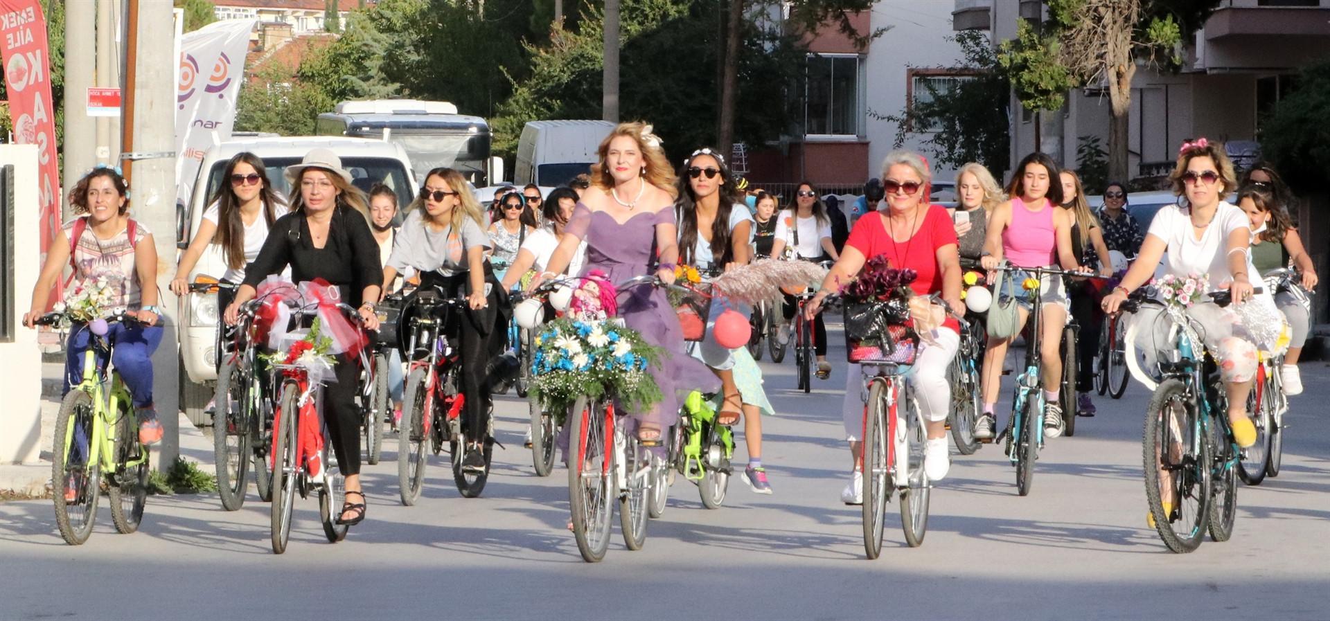 Fancy women push pedals to mark car-free day