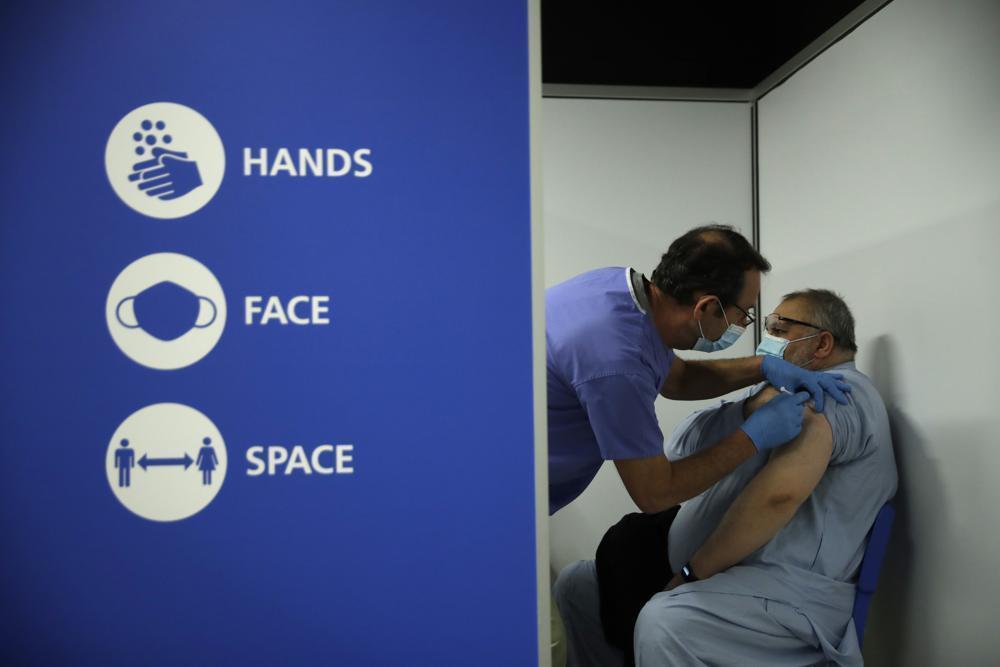 UK counts on vaccines, common sense to keep virus at bay