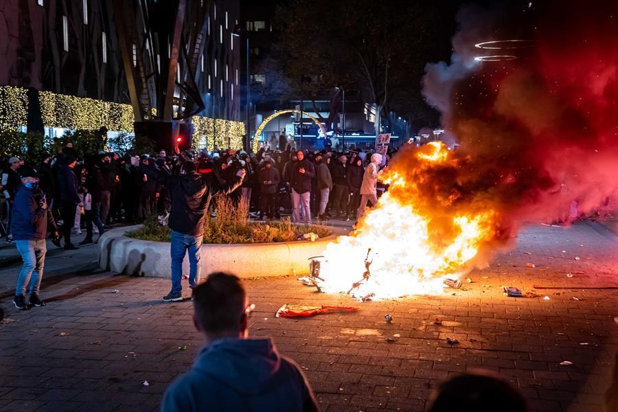 Dutch police fire warning shots as Covid riots hit Rotterdam