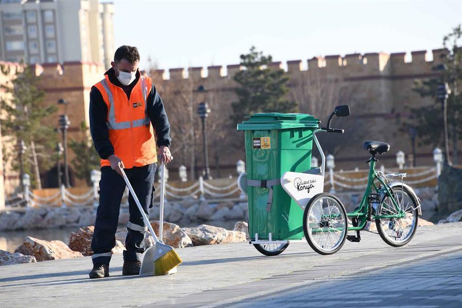 Sanitation workers with bikes on roads in Konya