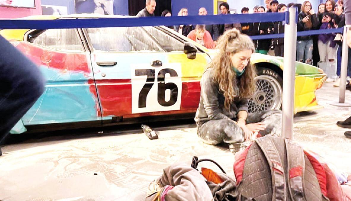 Climate activists cover Andy Warhol work with flour in Milan