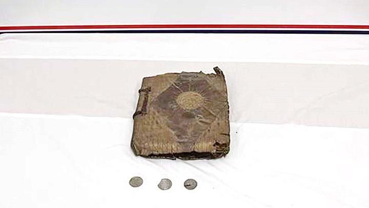Handwritten Bible and three coins seized in vehicle