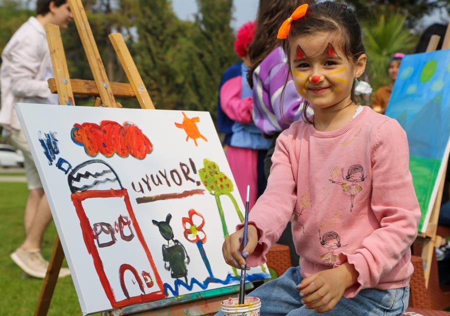 Quake survivor children painting at seaside