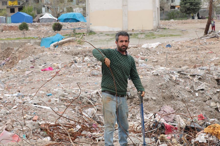 Man collects iron from debris to make money
