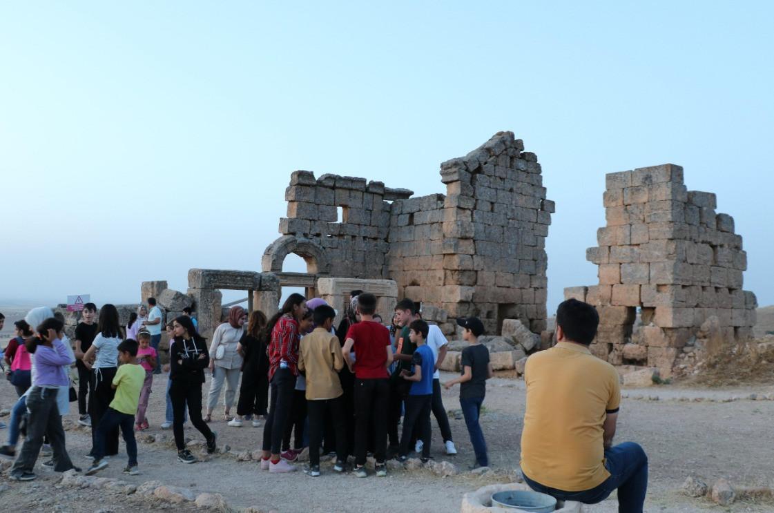 People observe sky from ancient castle
