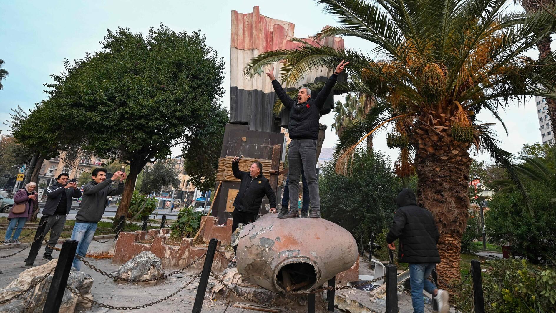 With regime toppled, Syrians take down statues of late Hafez al-Assad