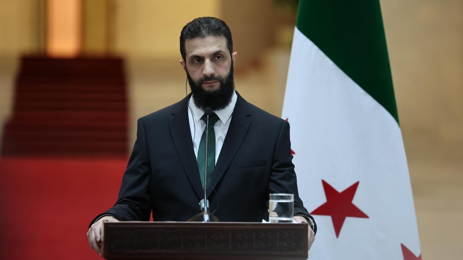 Syrias new leader says all weapons to come under state control