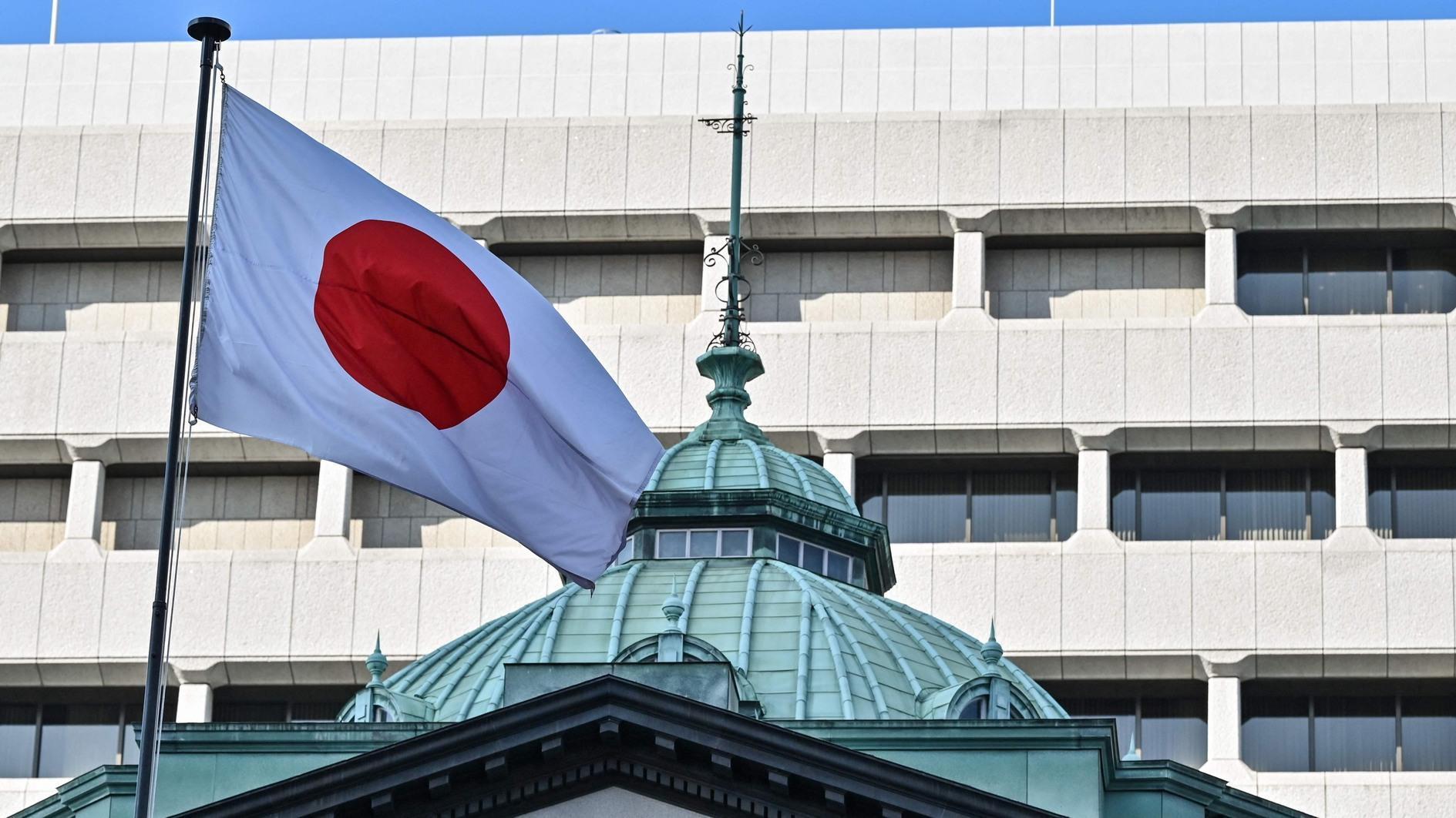 Bank of Japan holds rates, warning of uncertainty