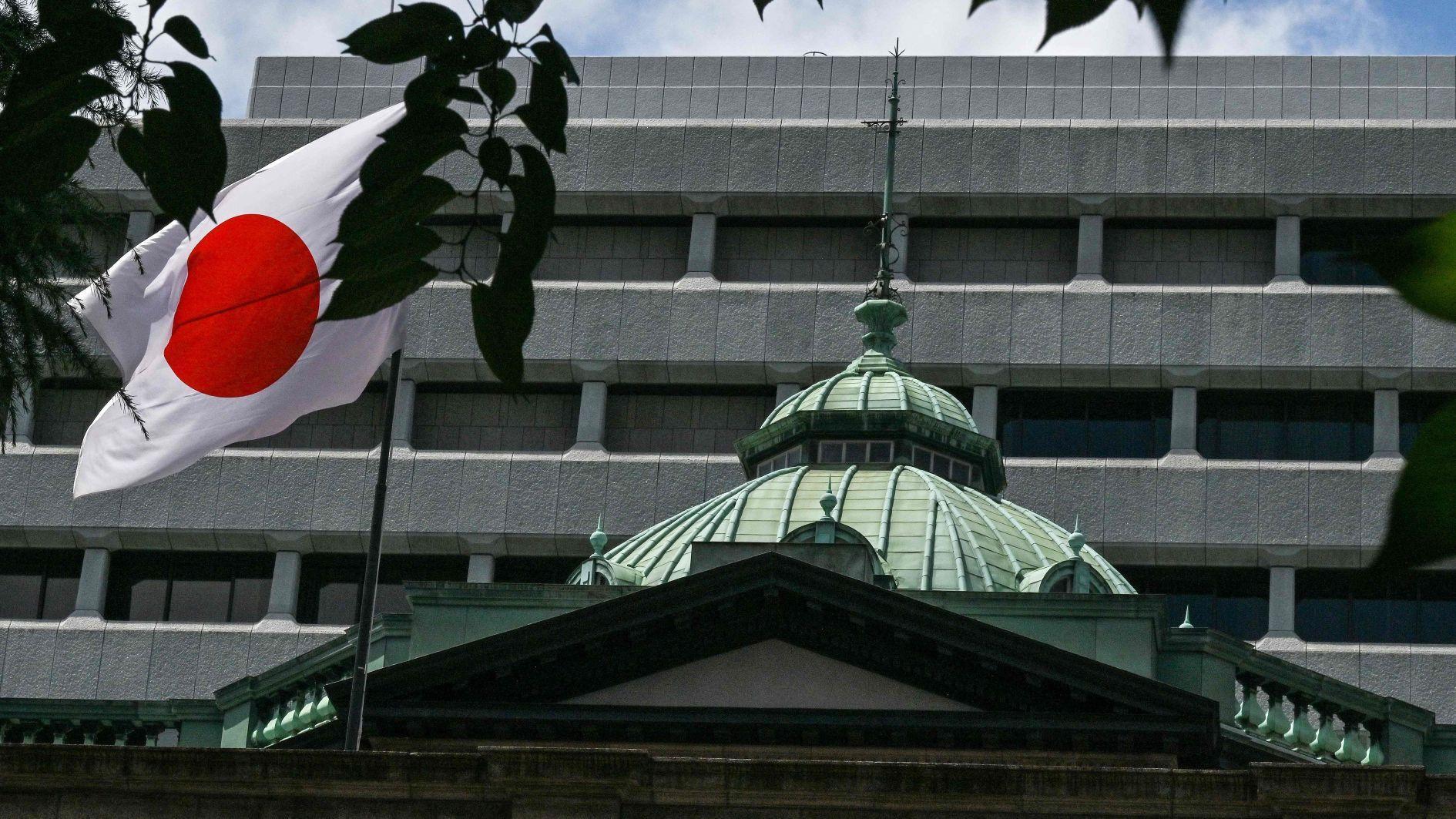 BoJ holds rates, says it will slow bond purchase taper