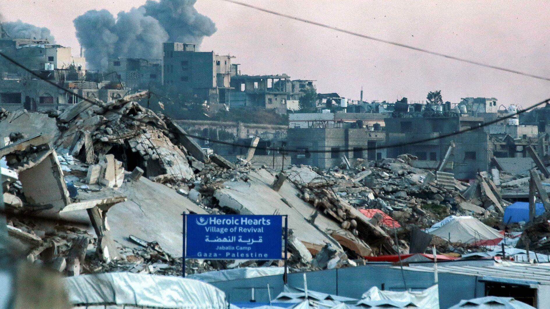 Gaza civil defense says Israeli attacks kill dozens near two aid centres