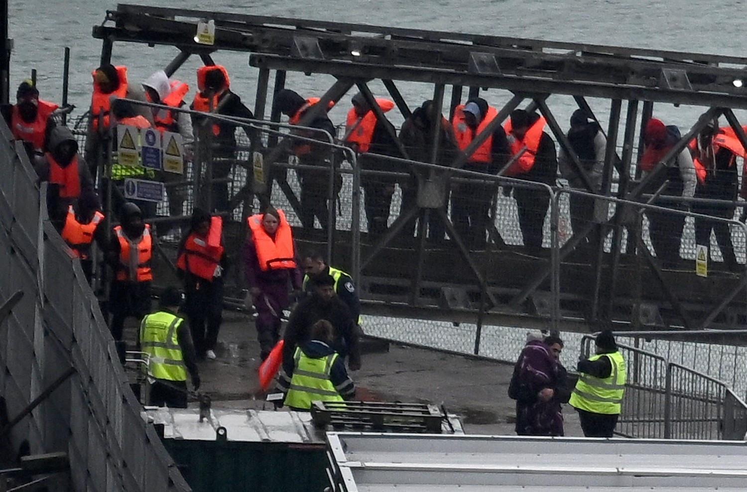 UK says first migrants held under return deal with France