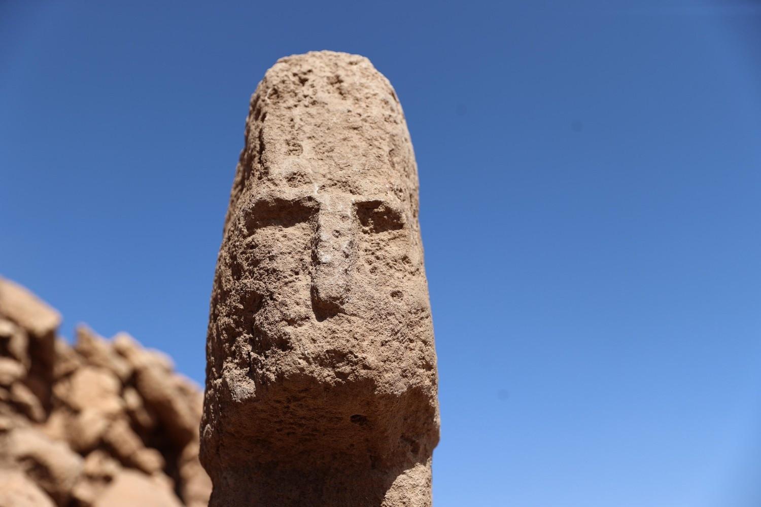 Face carving found on T-pillar backs human figure theory