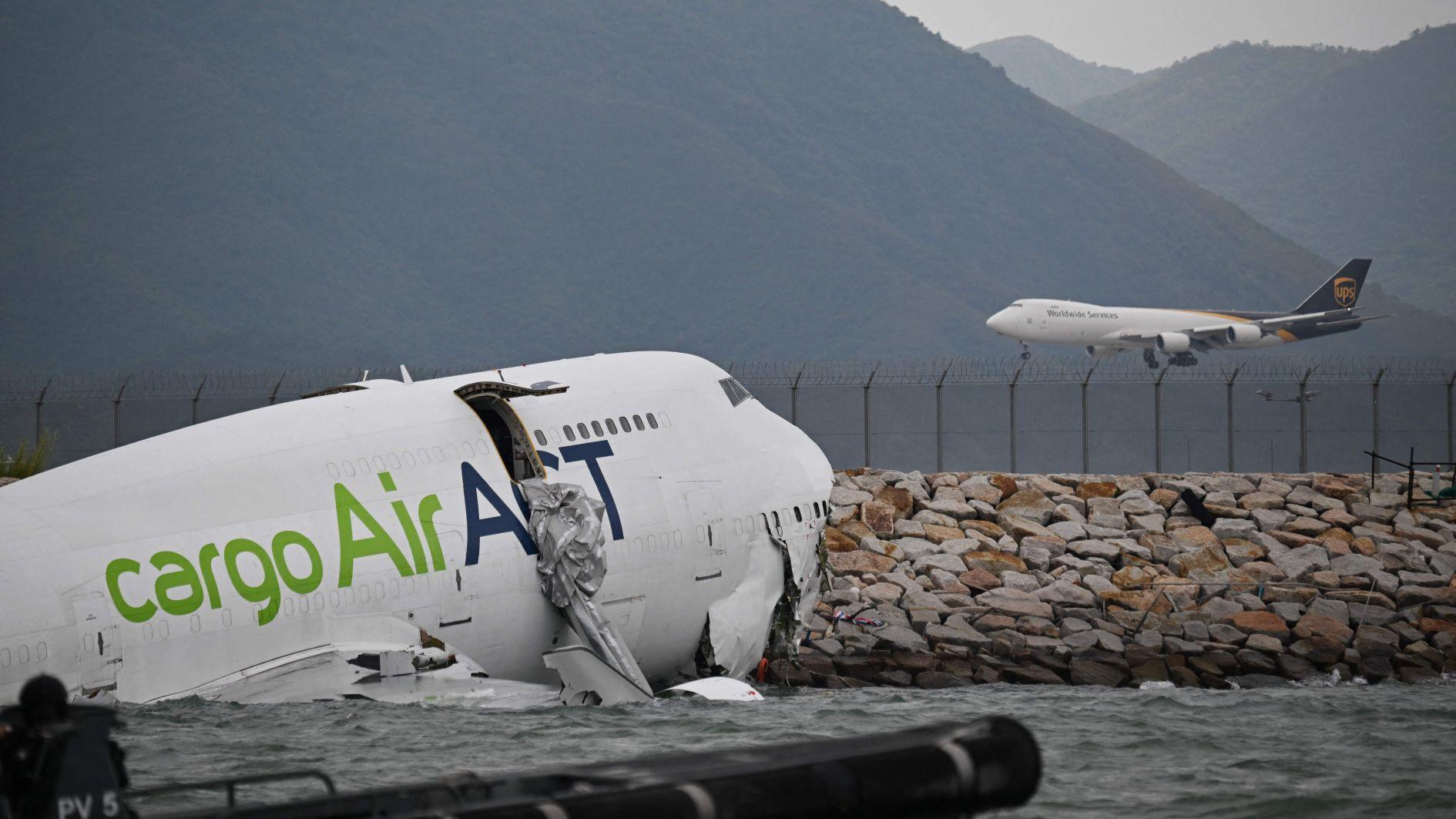 Cargo plane skids off Hong Kong runway, kills two