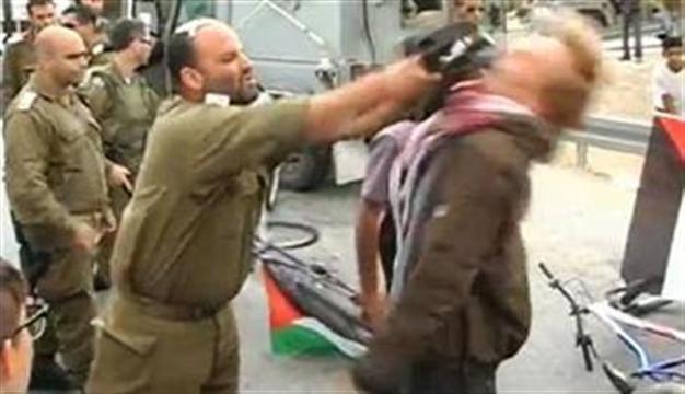 Israel officer reassigned after attack on activist