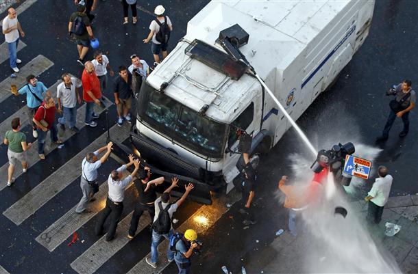 Police intervene with water cannons against protesters gathered at Taksim Square