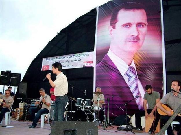 Turkish left-wing band Grup Yorum sings under al-Assad poster