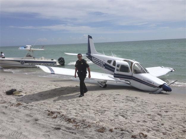 Plane crash-lands on US beach, killing father