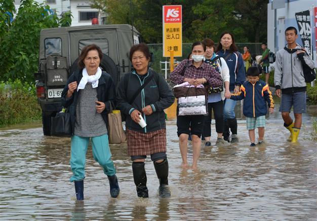 Thousands of rescuers deployed as Japan floods kill three