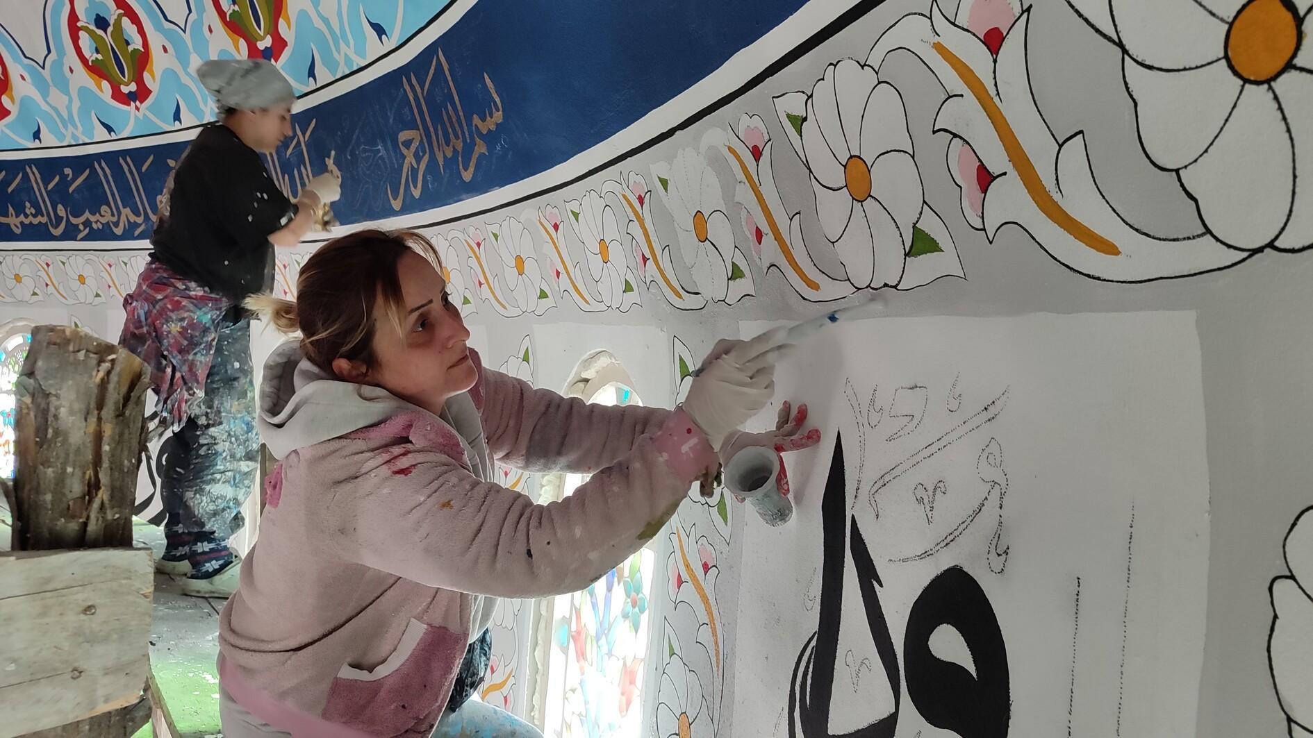 Women decorate mosque walls with intricate motifs