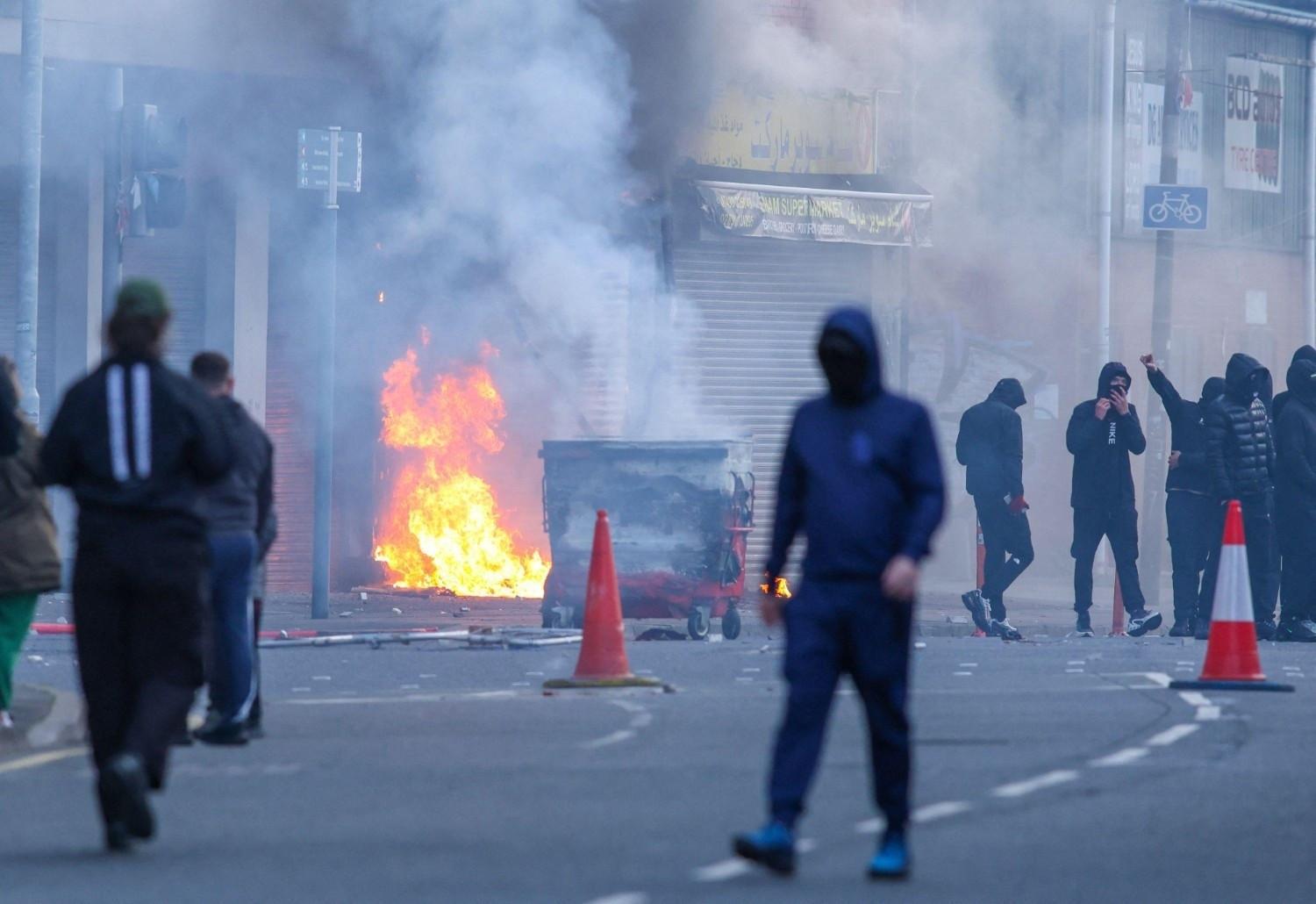 Protesters torch buildings and vehicles, block roads over Belfast stabbing