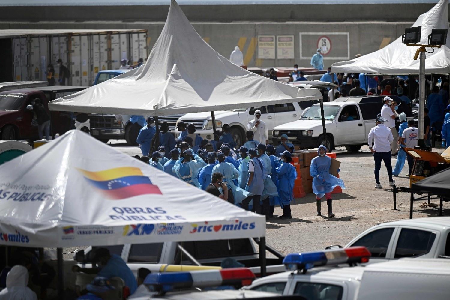 Key Venezuela port opens with US aid, as burials begin