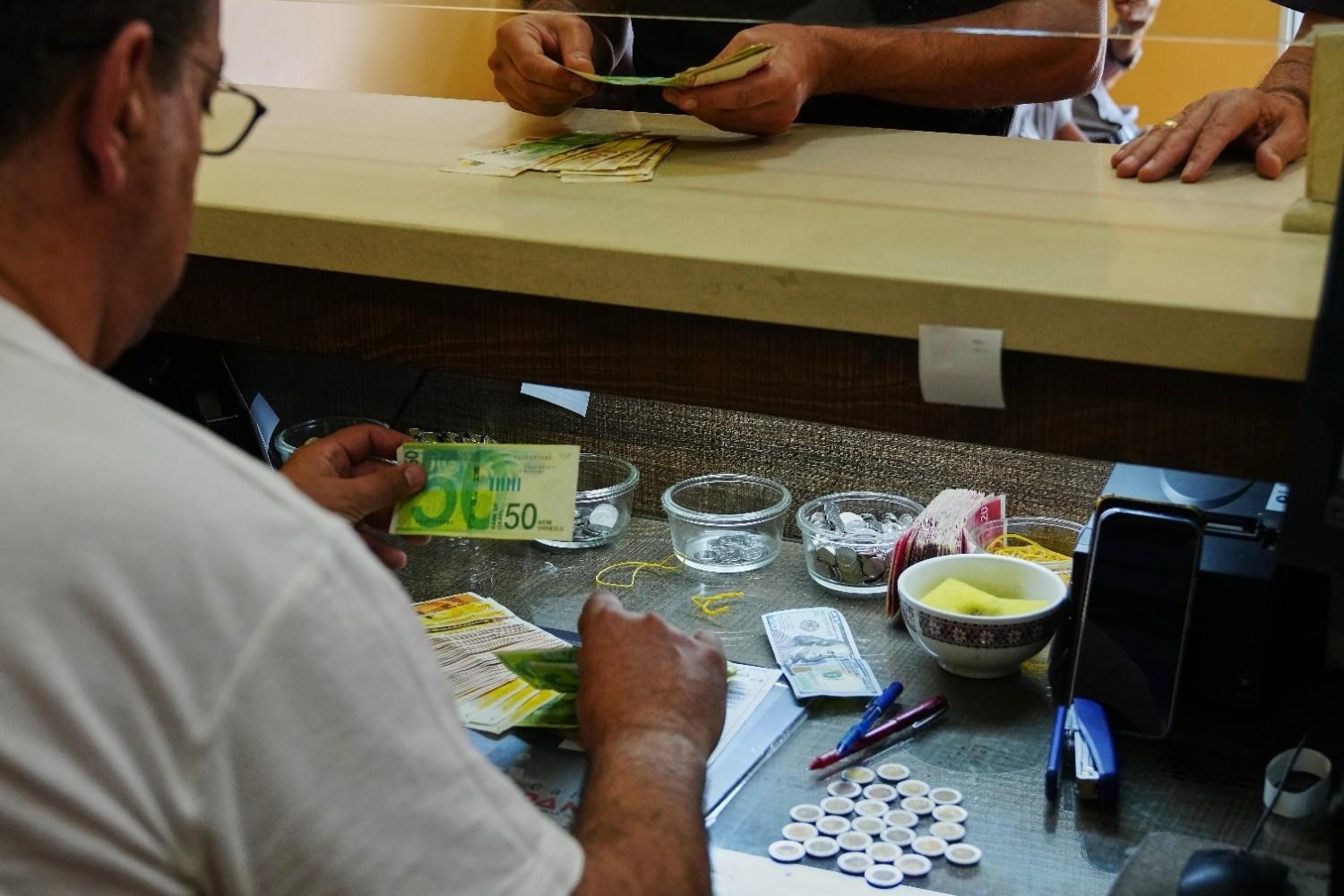 In Isareli-occupied West Bank, too much cash breaks economy
