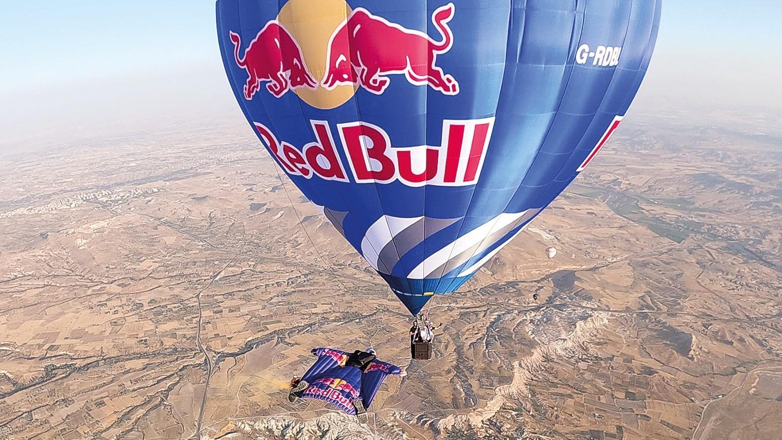 Wingsuit athletes fly among hot air balloons over Cappadocia