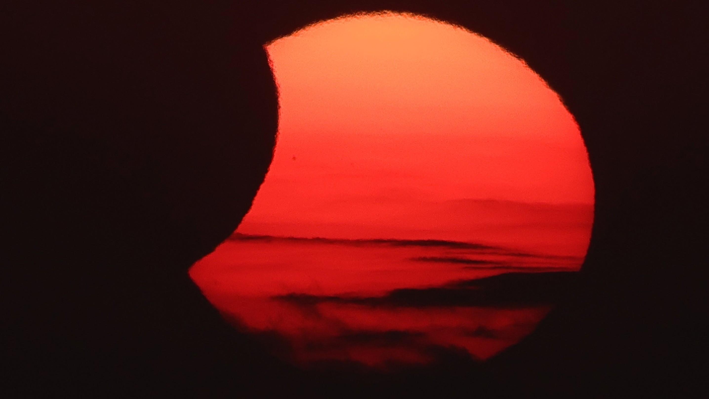 Spain darkens as solar eclipse races south from Arctic